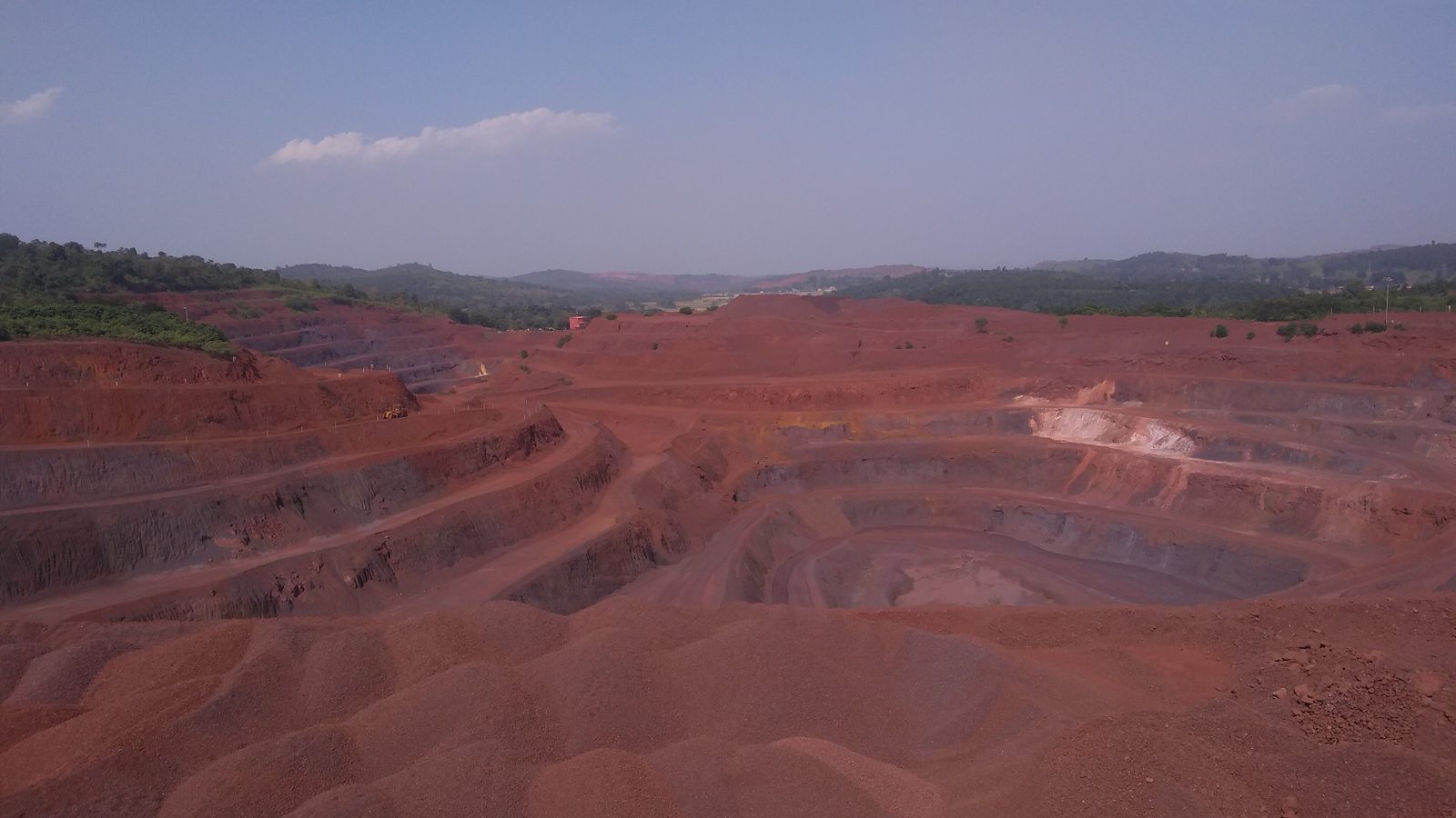 A large benched open-pit iron ore mine in Keonjhar district, Odisha